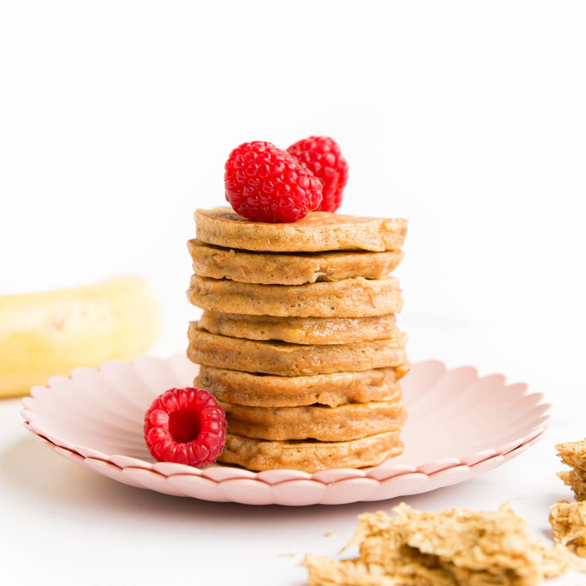 Stack of Weetabix Pancakes on a Plate Topped with Raspberries.